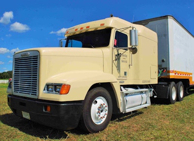 Lewis Cantrell of DTP Chrome Shop in Spartanburg, S.C., brings his old United Van Lines moving trailer to the Southern Classic every year, using it as a display trailer to sell chrome parts. Shown here during set-up Friday, newly pulling the trailer was the 1990 Freightliner FLD mid-roof, powered by a Caterpillar 3406E. A customer sold him the unit after some years of Cantrell borrowing other trucks for the purpose.