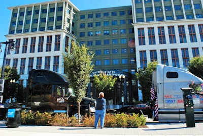Among issues echoing around the area at DOT headquarters included those of the ELD mandate, hours regs, detention and parking. Pleas were also made for DOT to allow use of the bathroom to demonstration participants — a jab at shippers and receivers who refuse to allow drivers to use their facilities. The rig in the left in this picture is Garland, Texas-based Doug Viaille’s Goat’s Transportation 2014 Cascadia. “You’ve got to have rules and regulations,” he says. “But the hours of service need to be looked at again” for much-needed revision, he says.