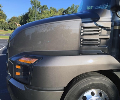 A side view highlights the aerodynamic hood’s aggressive slope.