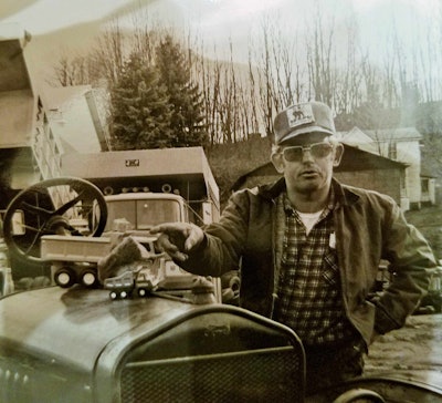 Carl Rhodes, pictured here with a 1919 International truck Rick says he took to parades at the time of the photo.