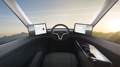 The cockpit of the Tesla Semi features a panoramic windshield, a single seat and two touchscreen displays, borrowed from Tesla’s Model 3 passenger car. The displays on both sides of the driver provide access to navigation, blind spot monitoring and electronic logs.