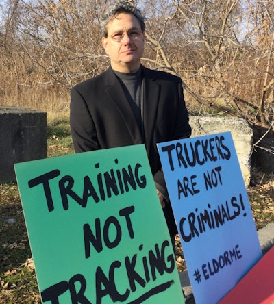Truckers turned out on Dec. 4 for an “ELD Media Blitz.” Shown is Buffalo, N.Y.-based owner/operator Pat Valenti with some of the signs at the Syracuse event.