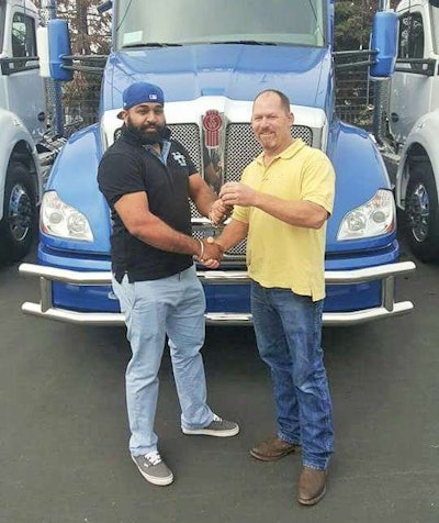Atwal and a salesman on the day he inked the deal on the KW.