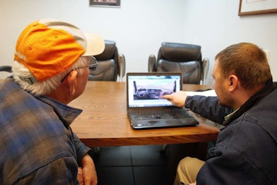 Boyd (left and Corey Price working with the International truck configurator program on Price’s laptop to assess interior options in the new International LT tractor Boyd’s spec’ing.