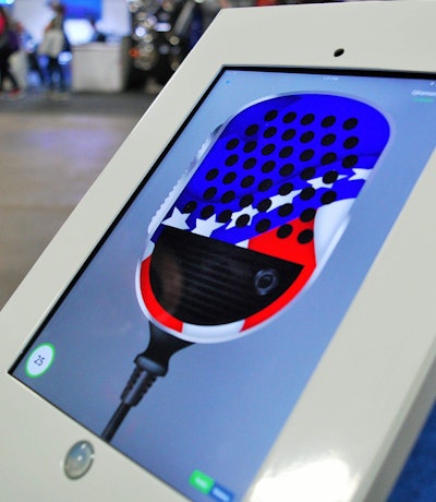 Truckers using Ezlogz social features can send live messages via a push-to-talk feature. The system is stylized as a CB radio microphone.