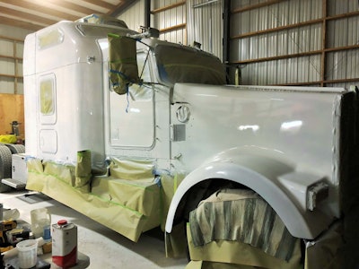 After the first coat of paint was laid on, above, Salmon spent some prep time streamlining things by removing hood KW emblems and other extraneous items and filling holes, sanding, priming, painting, then sanding down again.