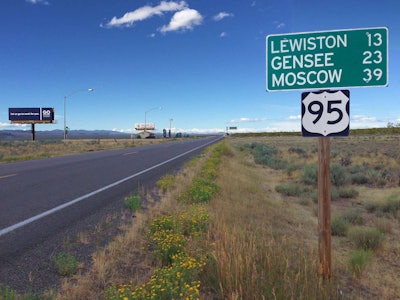 Lewiston, Gensee, Moscow mile marker sign and HWY 95 sign by long stretch of road
