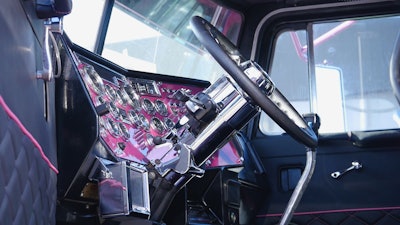 The interior has been redone to match the exterior with a pink dash, black floors and upholstery with pink accents and more.