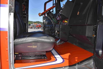 The floor has the same orange, white and purple color and stripe scheme as the truck’s exterior.