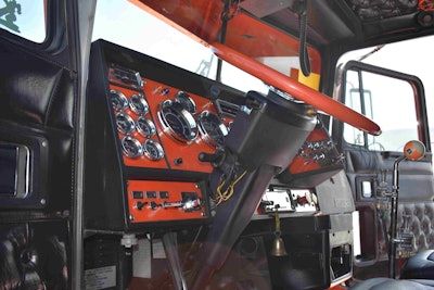 The dash and steering wheel are orange to match the truck’s exterior. He even added a billiards ball as a shifter knob to match.