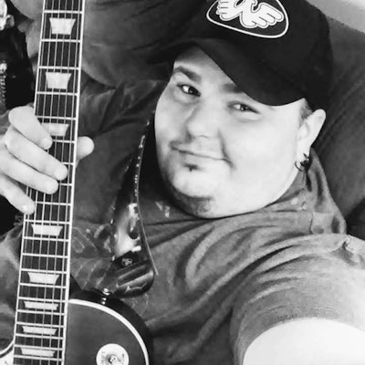 Cody Brunner holding his guitar