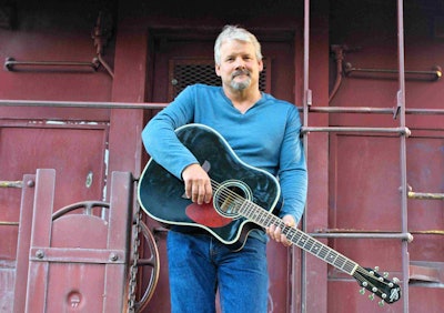 Mark Bolding holding his guitar