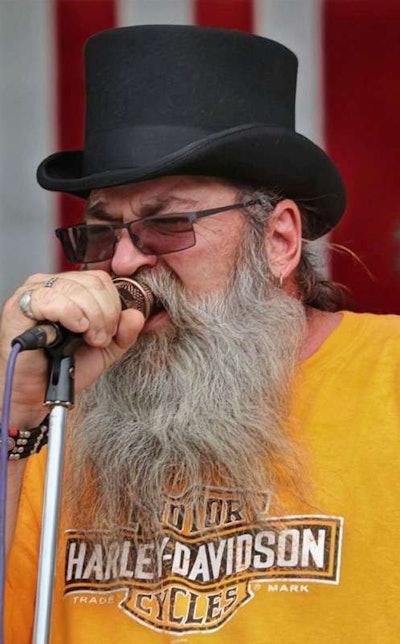 Scott Henry singing into a microphone