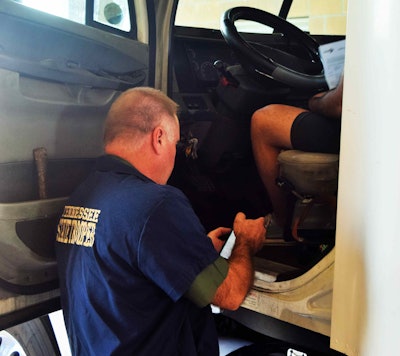 Sergeant Mills flipping through owner-op Alfonsoâs ELD.