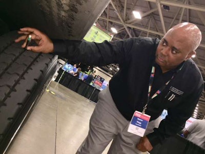 Homer Hogg of TA/Petro demonstrates the free tire depth gauge that is given to each contestant.