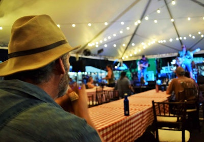 ‘Long Haul Paul’ Marhoefer riffing with his harmonica while looking on at the Kingsport, Tenn., Stone Creek Four performed Thursday at the TA Petro Parking Community at GATS. Marhoefer’s report from the driver-led St. Christopher fund auction the same location on Saturday follows: