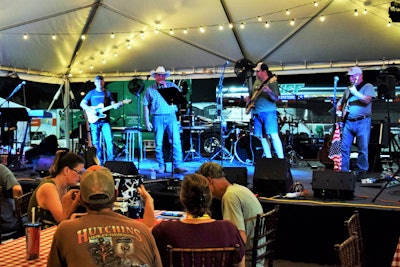 Part of the draw to the parking lot community last year was the Stone Creek Four band, here shown backing Heniff Transportation driver and singer Brad James. They are set to return again for 2019’s show.