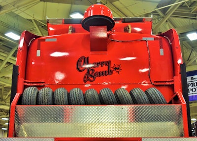 Trailer tire flats are a frequent enough occurrence toting manufactured housing to warrant a tire rack of this size, pictured at GATS behind the cab of their 1999 W900L, note Delbert and Chris Jones of the Jones & Sons small fleet.