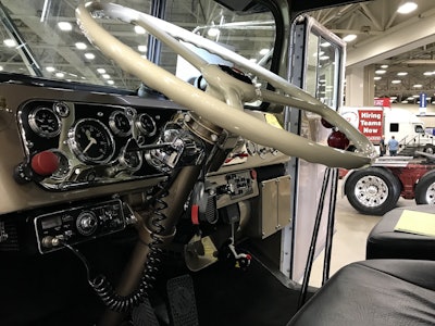 The interior features the original steering wheel and OEM gauges, and is painted the original gold that the truck had in 1955.