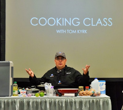 Trucker Tom Kyrk, pictured onstage at GATS, where he delivered several demos for attendees centered on the culinary arts in practice on the truck.