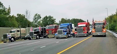 The scene Saturday morning headed out of D.C. on I-95 with a convoy en route back to Fredericksburg, Va., as “10-4 on D.C.” convoy participants momentarily stopped traffic. Event and United States Transportation Alliance rep Brian Brase (in the blue Pete at center above) called this and one other brief stop (on I-395) a “warning shot” intended to give regulators/legislators a hint at what alternatively could result from failure to act on drivers’ concerns.