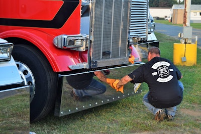 Since his participation in October 2017 Congressional outreach/protest events with ELD or Me, then one-truck, Wis.-based owner-operator Rob Hallahan, here shown contributing to the shining of owner-op Brian Bucenell‘s front bumper, has taken on three owner-operators under his authority, one with two trucks, to make a five-truck operation. With that experience under his belt, he says he’s become somewhat ambivalent about the ELD time clock given tracking functionality is useful in, for instance, eliminating a bevy of calls in load management/dispatch. He echoes other operators’ concerns with the lack of 14-hour flexibility in the hours rule, however, and continues to view the regulated imposition of ELDs as unnecessary.