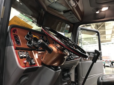 The truck’s dash and steering wheel are also painted brown with red and black accents to match the rest of the truck’s color scheme.