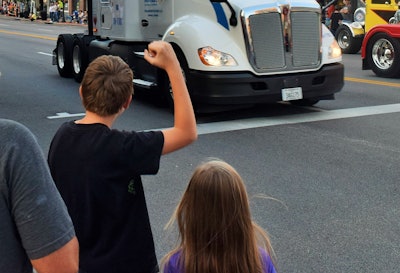 Child signaling for truck driver to pull the horn