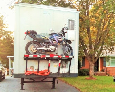 Owner-operator Kenny Capell carries his motorbike on this platform mounted to the front of his van. Using a modified crane and winch, Capell can load and unload the unit quickly.