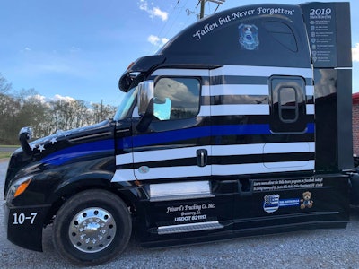 The truck features white stripes with one blue stripe to signify the “Thin Blue Line.”