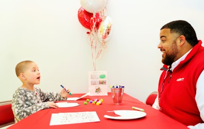 Isaiah Woodard (right), Averitt’s Fort Myers service center director, smiles during time spent crafting with a St. Jude Children’s Research Hospital patient during a recent company visit to the facility.