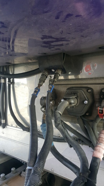 At the far left are coolant lines, running from the condenser into the cab. The two lines in the center with the blue attachments are electrical lines. Jaikes explains the system in his own words in an installment of BigRigVideos’ Rolling CB Interviews series, by Chris Fiffie. The video, “Precision Transport,” is in the BigRigVideos playlist at Youtube.com/Overdrivemag — scroll to the 9:50 point on the video. (Find it embedded in this post at bottom as well.)