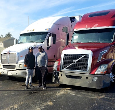 Owner-operators Donte Ogletree (left) and Andre Jackson and two of the three trucks in operation in their young Midnight Xpress fleet near the beginning of the year. Navigating insurance and hiring challenges has presented big barriers to aggressive growth plans.