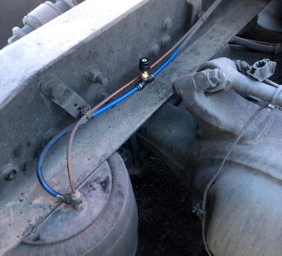 The Air Scale sensors, Riegel says, come with a “very simple install,” with the sensors placed at each air control valve with a push-to-connect Tee fitting, as shown on a drive axle here.