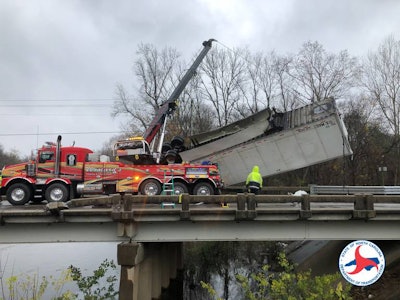 Workers recover a tractor-trailer that plunged into the Neuse River in North Carolina. (NCDOT photo)