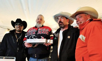 An auction was officiated by trucker-songwriter Taylor Barker (second from right, with James, right, and Mathis, far left), which raised $500 to recoup some of the costs Redneckazine incurred for putting on the event. Pictured here is one of the winners with the night’s talent.