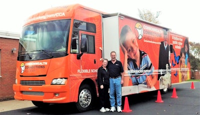 George and Diana Ruelens having picture taken outside of truck