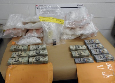 Twenty-three packages of suspected methamphetamine and two envelopes containing U.S. currency totaling $126,000 were seized by the CBSA at the Blue Water Bridge border crossing. (CBSA photo)