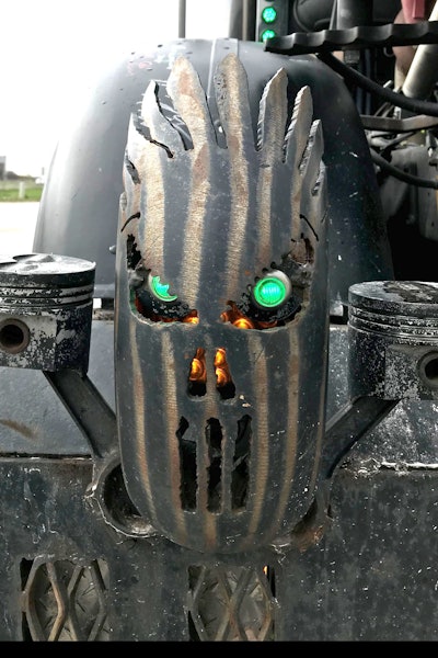 Hand-cut faces, lit from inside, sit on both corners of the front end.