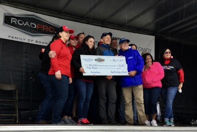 Members of the RoadPro Family of Brands staff present Make-A-Wish officials with a check for $30,000.