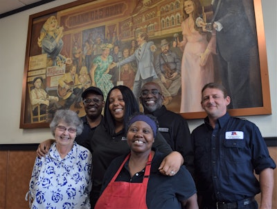The team you’ll hear in the podcast, from left: Longtime fuel-desk cashier Marie “Granny” Duke, tech Steve Whitmore, inventory manager in the service dept. Shay Rucker, Donna Dement (also on the fuel desk), regional service manager David Green, and tech Matt Lasher. They’re all standing in the vestibule to the interior of the place, where is displayed the painting above them featuring Nashville country music icons — it’s a holdover from before the flood that was able to be salvaged.