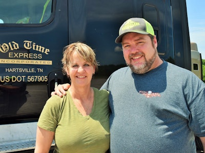 The Bryants outside the Old Time Express Freightliner they pilot.