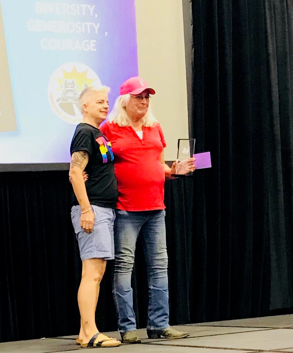The story of owner-operator Roni Hazel Sherman (pictured, right, with author Anne Balay) was told in part in Overdrive‘s recent coverage of LGTBQ issues in trucking. Sherman, a Vietnam veteran who began hauling in 1972, was recognized for inspiring “empowerment, generosity and courage,” RWIT says. Sherman has driven everything from dump trucks to cement mixers and milk tankers, but found her love doing open deck.