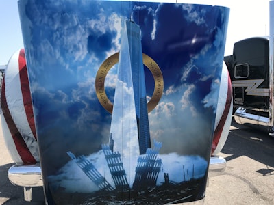 Inscribed on the halo around the building are the words “September 11, 2001 – Never Forget”.