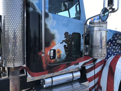 The passenger’s side door shows firefighters battling a blaze.