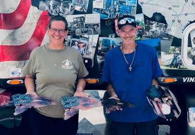 Mark and Holly O’Donnell, leased to Bennett Heavy and Specialized, pictured next to their show-winning truckers-celebration mural-wrapped Peterbilt 579.
