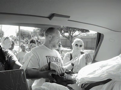 Claxton (center) in Dallas during the outreach initiative of his and colleagues’ Truckers Feeding the Homeless group. Read more about the Dallas effort and the history of the group via these links.