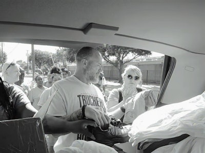Claxton (center) in Dallas during the outreach initiative — still here is taken from the group’s documentary video (below and at this link) of the effort.