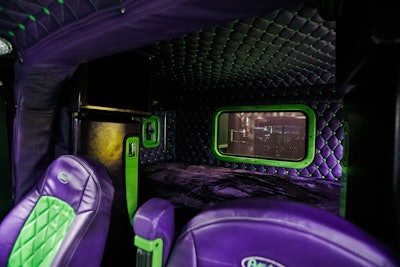 The roof and sleeper compartment feature button-tuck lining to match the truck’s purple and green color scheme.