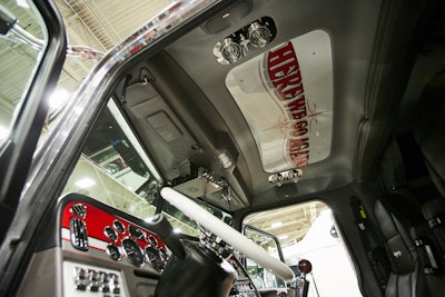 The interior is custom-painted to match the exterior color scheme, including a roof panel with the truck’s name.